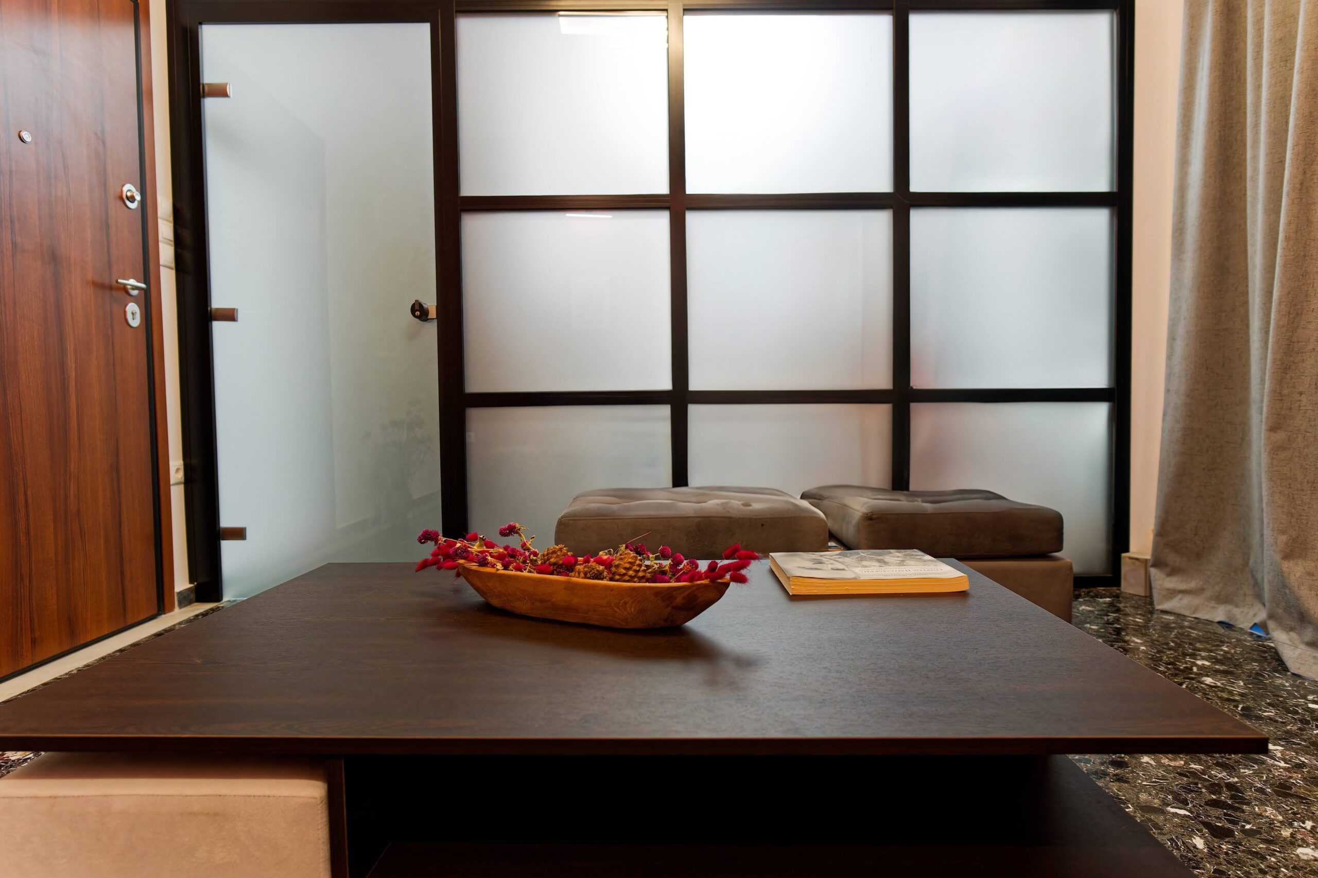 Modern waiting area with frosted glass partition and coffee table
