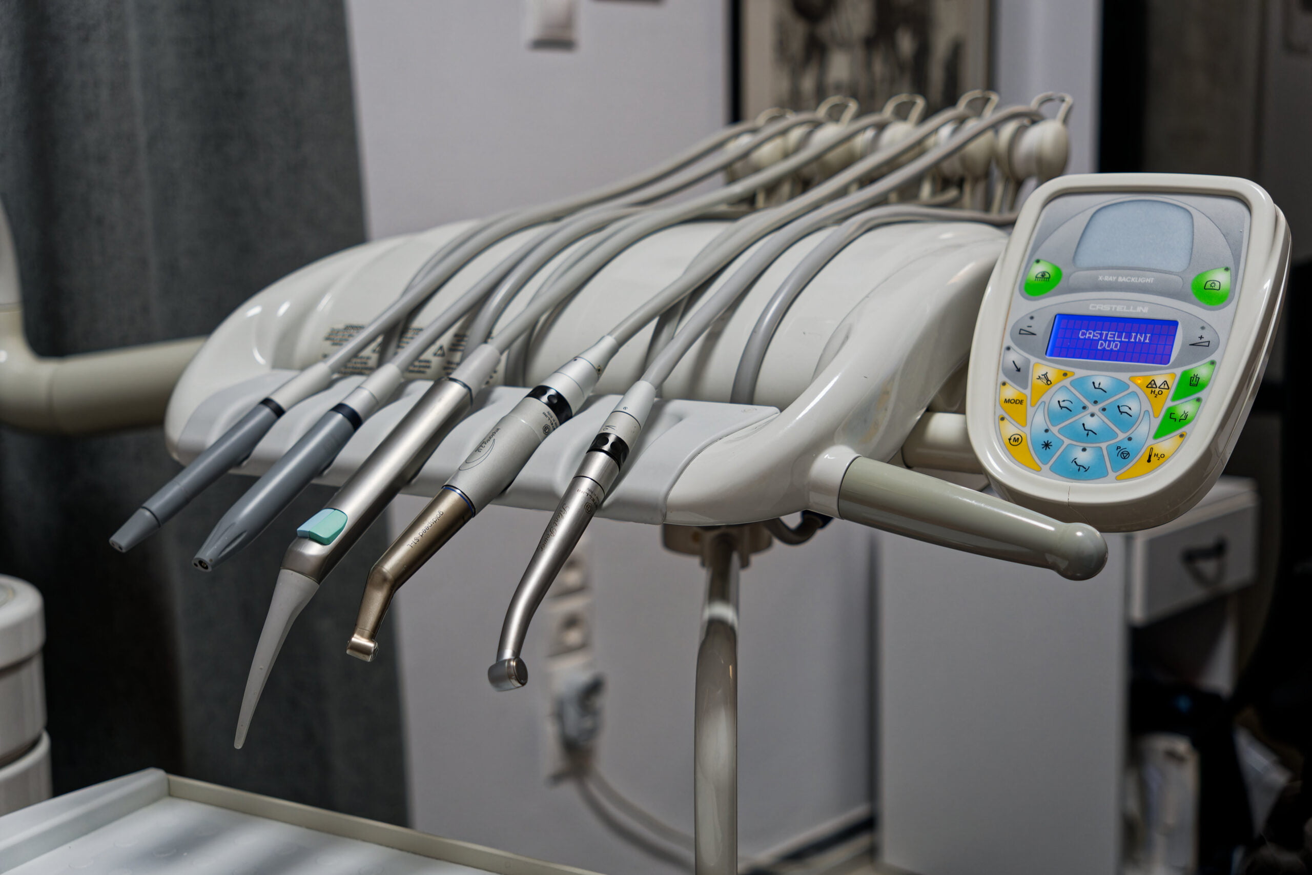 Dental chair with overhead-mounted instrument tray and tools